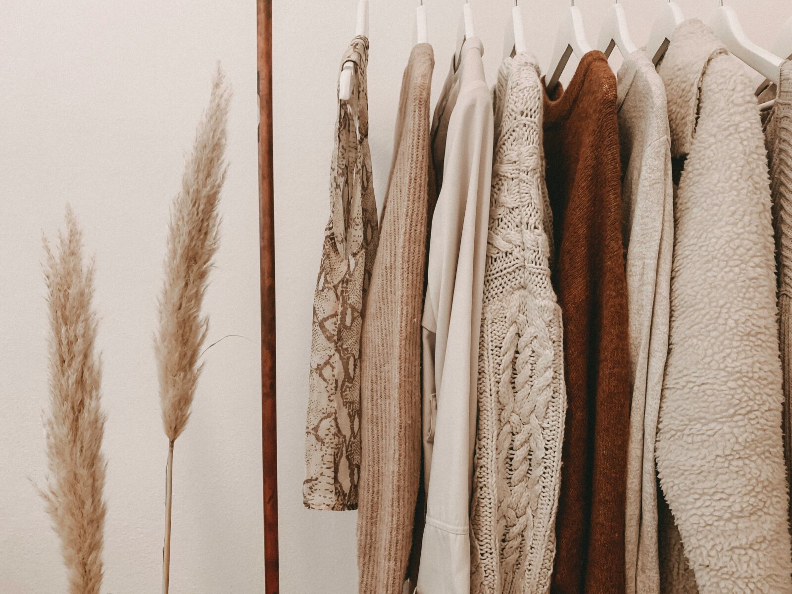 Sustainable clothing rack with neutral outfits for best sustainable fashion brands