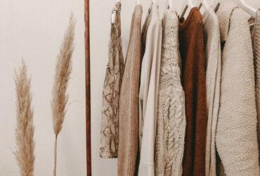 Sustainable clothing rack with neutral outfits for best sustainable fashion brands