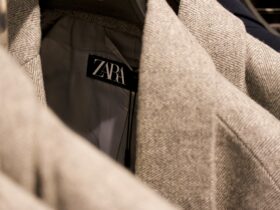 Is Zara fast fashion — close-up of Zara label on tweed jacket in clothing rack