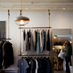 Clothing store interior with shirts and jackets on racks, showing a stylish retail display for top garment brands.
