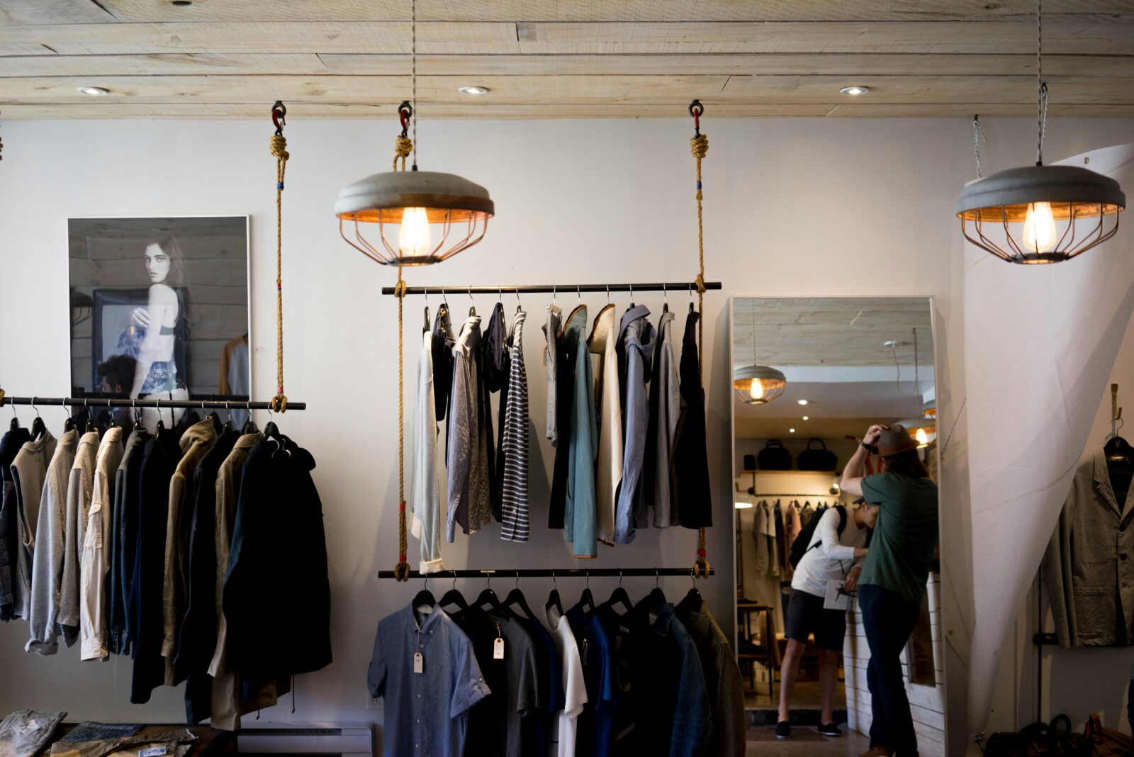 Clothing store interior with shirts and jackets on racks, showing a stylish retail display for top garment brands.