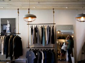 Clothing store interior with shirts and jackets on racks, showing a stylish retail display for top garment brands.