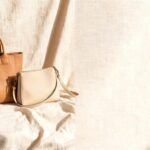 Elegant pre owned designer bags displayed on a neutral background in a soft luxury setting.