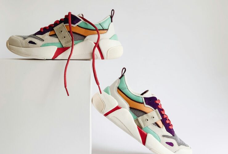 Colorful used designer shoes displayed on a white background.