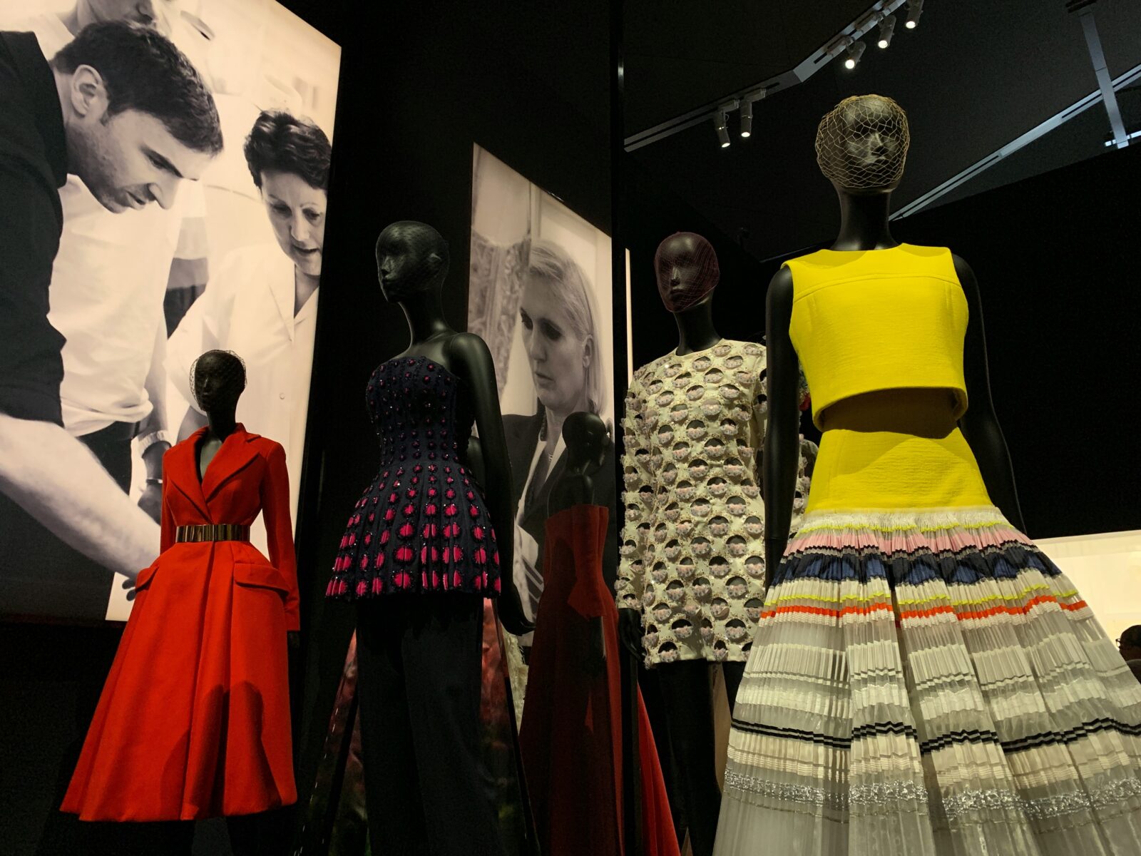 Fashion exhibition with mannequins wearing colorful designer outfits for fashion trends.