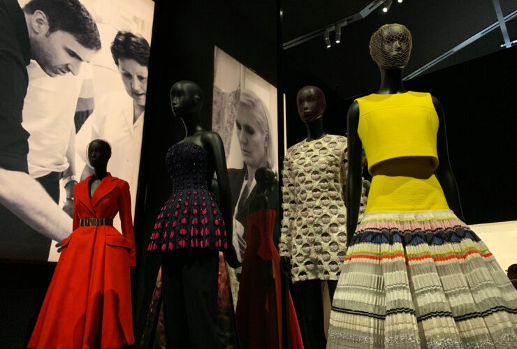 Fashion exhibition with mannequins wearing colorful designer outfits for fashion trends.