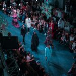 Fashion runway show with models and audience at New York Fashion Week.