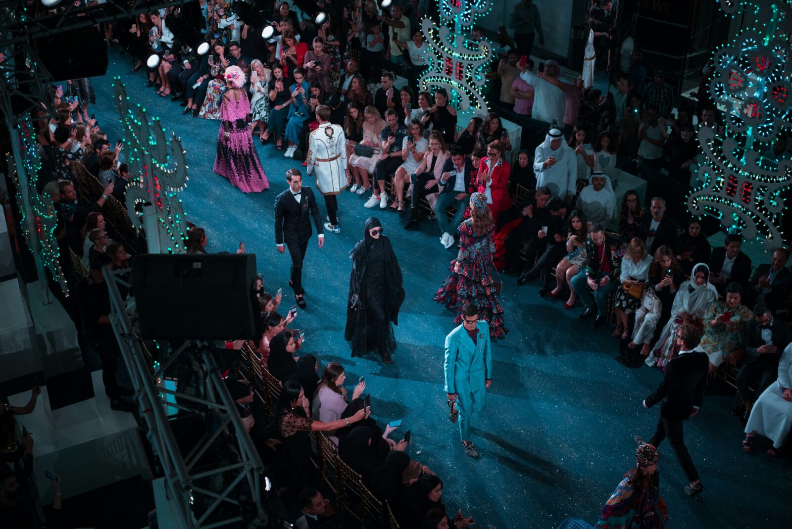 Fashion runway show with models and audience at New York Fashion Week.