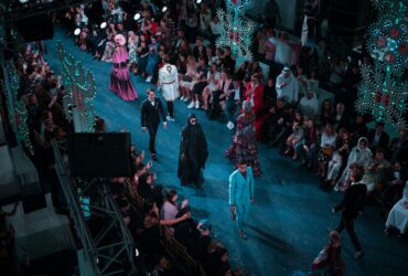 Fashion runway show with models and audience at New York Fashion Week.