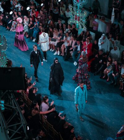 Fashion runway show with models and audience at New York Fashion Week.