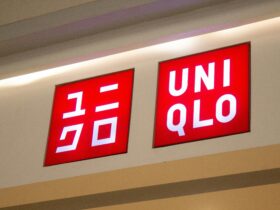Uniqlo Fast Fashion store signage displaying red illuminated logo with Japanese katakana text on retail storefront