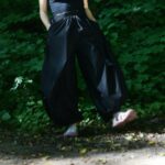 Woman wearing a fitted tucked top with tailored wide leg pants
