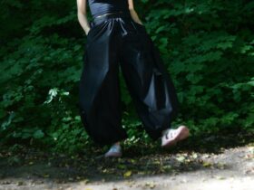 Woman wearing a fitted tucked top with tailored wide leg pants