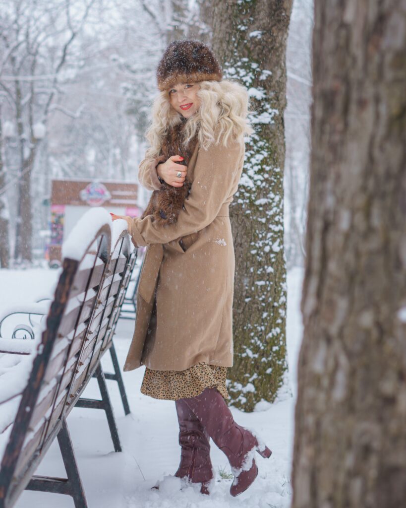 Are trench coats in style: woman wearing a classic beige trench coat
